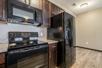 Kitchen with GE appliances and microwave at North Pointe Villas